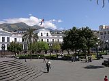 Ecuador Quito 02-05 Old Quito Plaza Grande Presidential Palace The white symmetrical building with a long row of columns at the Plaza Grande with the national flag flying is the Presidential Palace. The third floor of the palace is used as the President's private quarters where he lives along with his family.